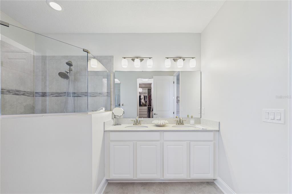 458 Convex Lane St. Augustine, FL 32095 - Photo 28 of 60 a bathroom with a sink vanity granite and a mirror