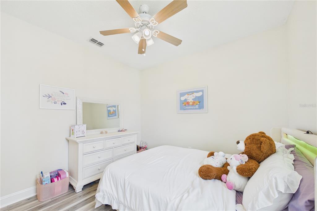 458 Convex Lane St. Augustine, FL 32095 - Photo 35 of 60 a bedroom with a bed and a chandelier