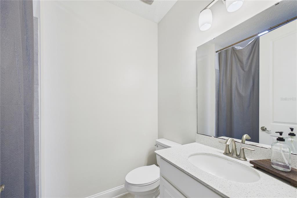 458 Convex Lane St. Augustine, FL 32095 - Photo 36 of 60 a bathroom with a sink a toilet and mirror