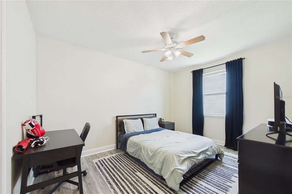 458 Convex Lane St. Augustine, FL 32095 - Photo 37 of 60 a bedroom with a bed and a chandelier
