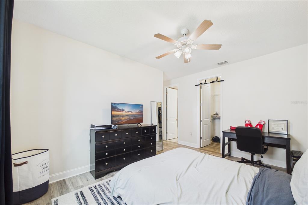 458 Convex Lane St. Augustine, FL 32095 - Photo 38 of 60 a bedroom with a bed and a chandelier