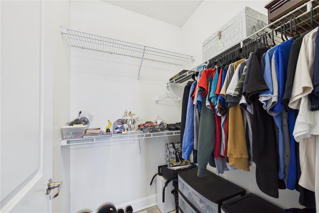 458 Convex Lane St. Augustine, FL 32095 - Photo 39 of 60 a view of walk in closet with clothes and shoes