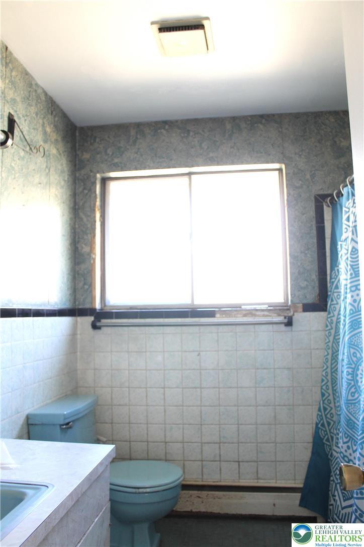 2465 Jacksonville Road Bethlehem, PA 18017 - Photo 17 of 28 a bathroom with a sink a toilet a window and a shower