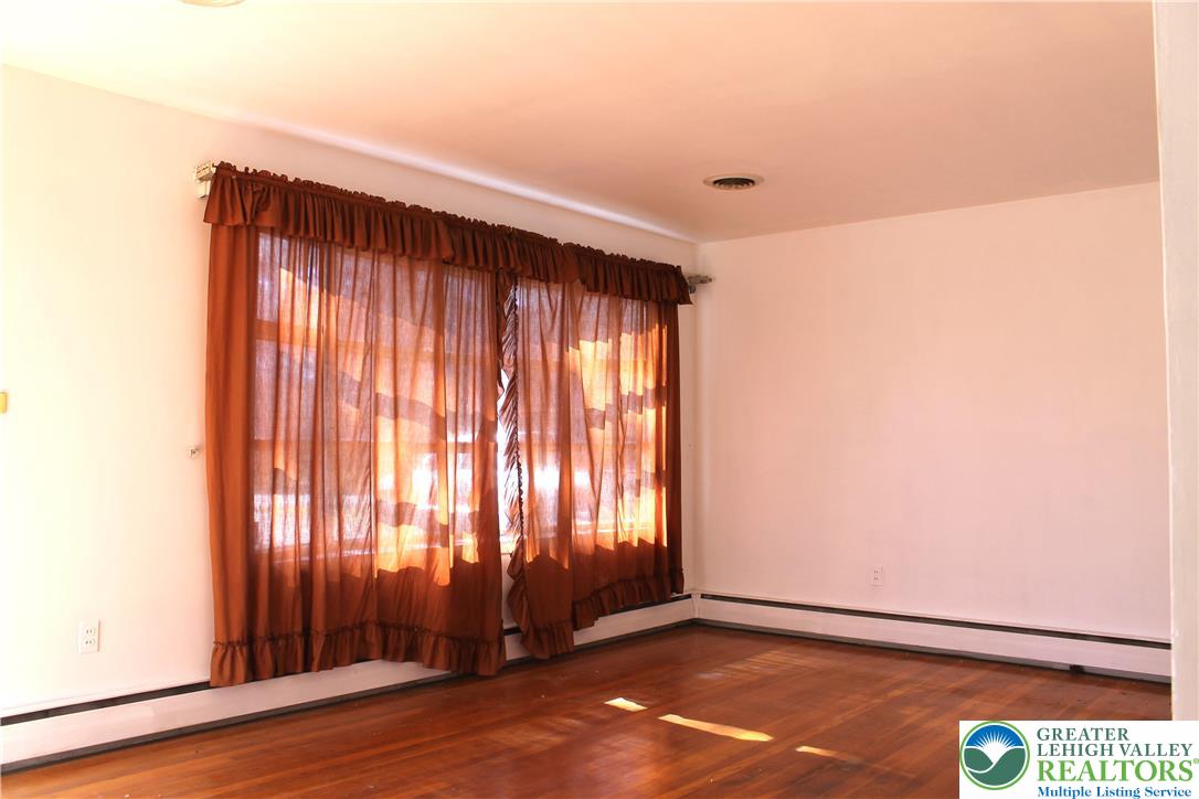 2465 Jacksonville Road Bethlehem, PA 18017 - Photo 3 of 28 an empty room with wooden floor and windows