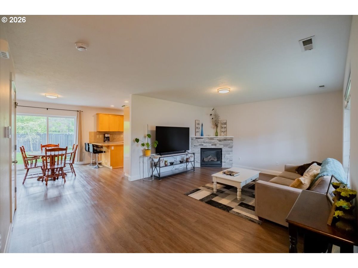 302 Division Street Northeast Silverton, OR 97381 - Photo 11 of 48 a living room with furniture and a flat screen tv