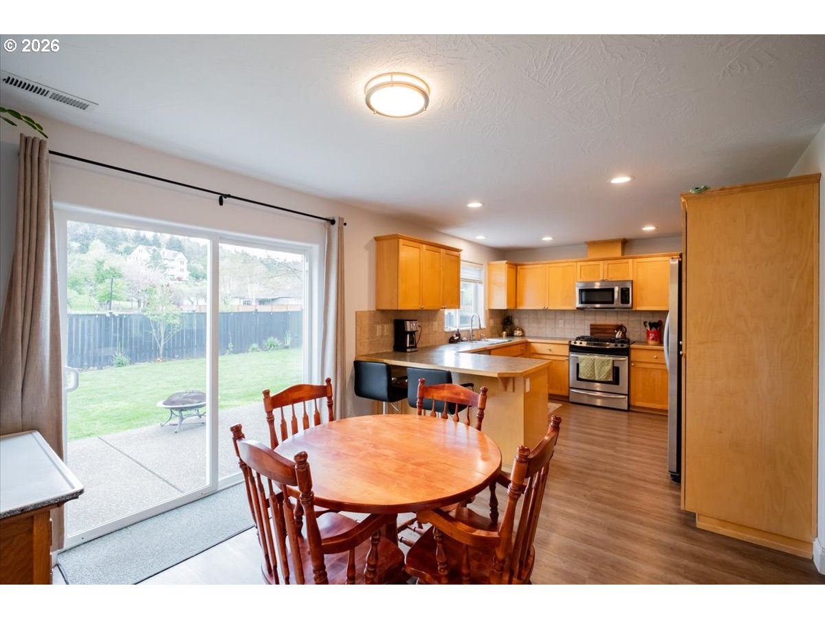 302 Division Street Northeast Silverton, OR 97381 - Photo 12 of 48 a dining room with a table chairs and a kitchen view