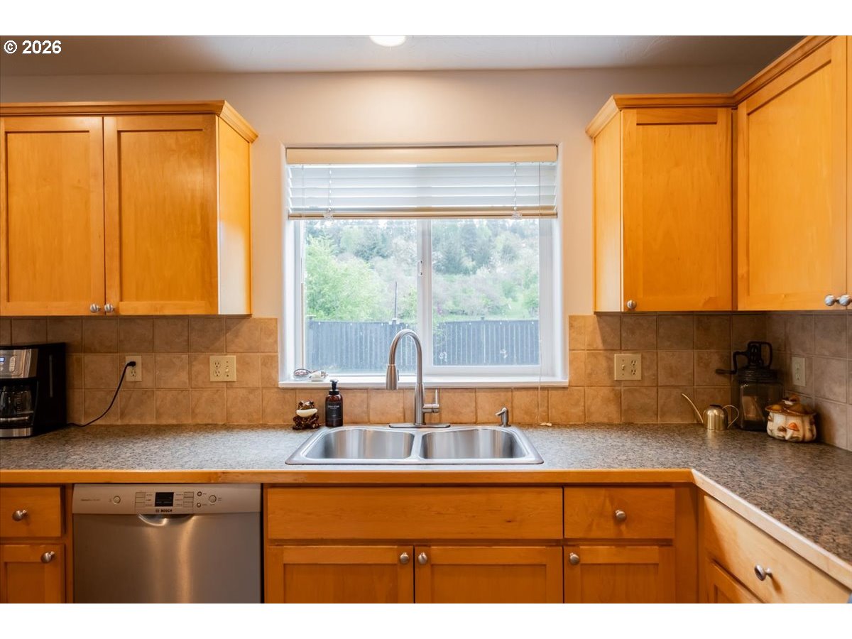 302 Division Street Northeast Silverton, OR 97381 - Photo 17 of 48 a kitchen with sink a window and cabinets