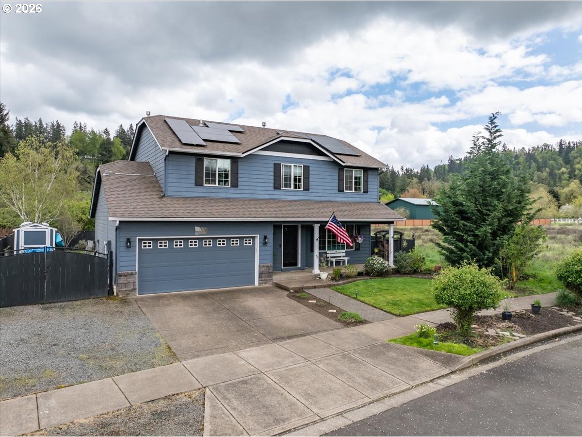 302 Division Street Northeast Silverton, OR 97381 - Photo 2 of 48 a front view of a house with a garden and trees