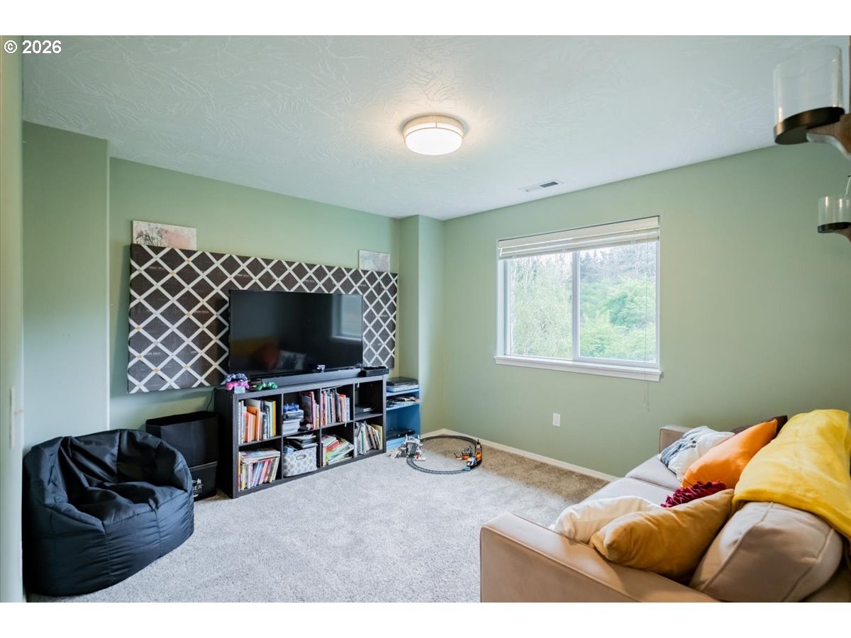 302 Division Street Northeast Silverton, OR 97381 - Photo 23 of 48 a living room with furniture and a flat screen tv
