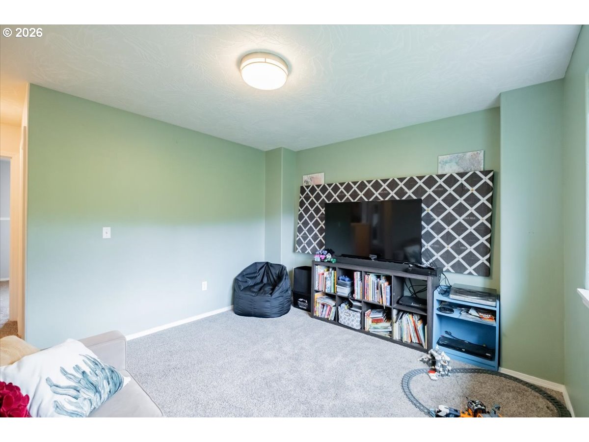 302 Division Street Northeast Silverton, OR 97381 - Photo 24 of 48 a living room with furniture a piano and a wooden floor