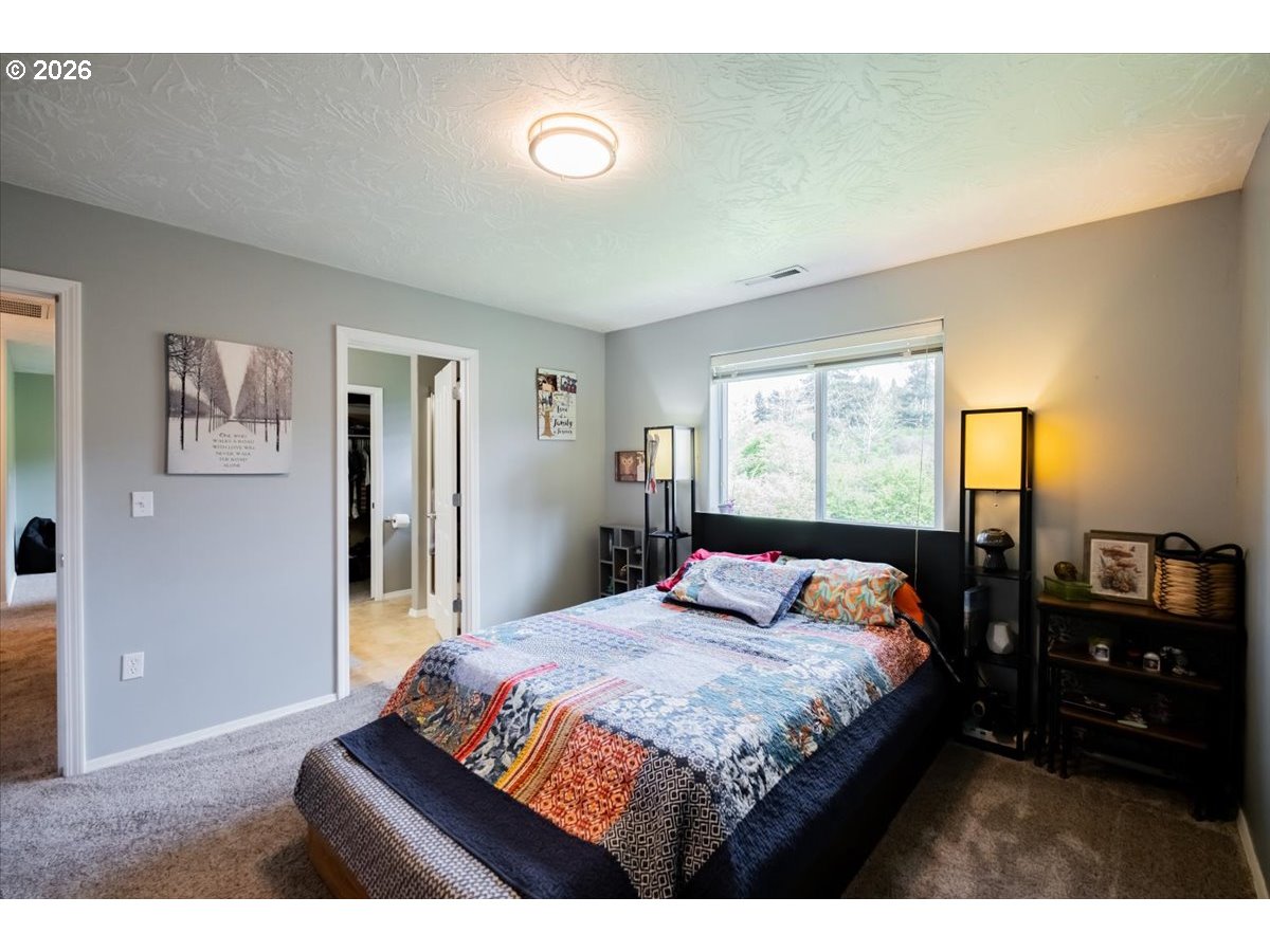 302 Division Street Northeast Silverton, OR 97381 - Photo 27 of 48 a bedroom with a bed and wooden floor