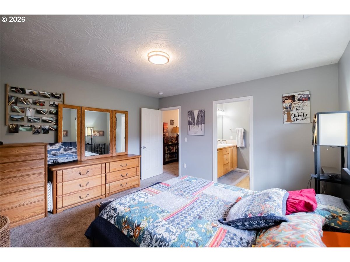 302 Division Street Northeast Silverton, OR 97381 - Photo 28 of 48 a bedroom with a bed and a dresser in it