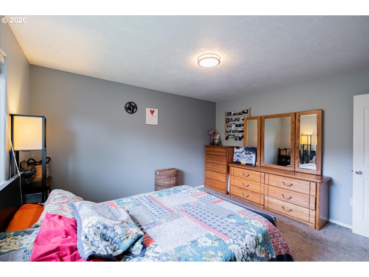 302 Division Street Northeast Silverton, OR 97381 - Photo 30 of 48 a bedroom with a bed and a television in it