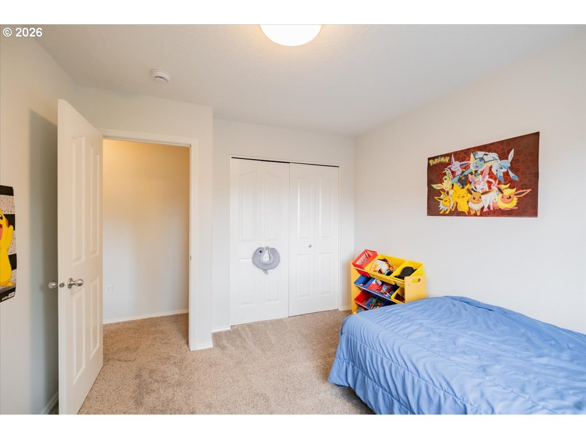 302 Division Street Northeast Silverton, OR 97381 - Photo 35 of 48 a bedroom with a bed and a painting on the wall