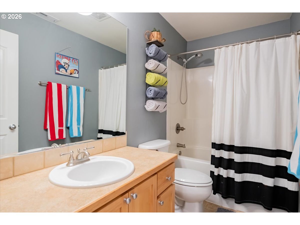 302 Division Street Northeast Silverton, OR 97381 - Photo 36 of 48 a bathroom with a sink a toilet and shower curtain