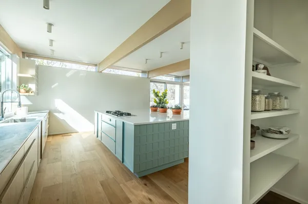 a kitchen with stainless steel appliances granite countertop a lot of counter top space and wooden floor