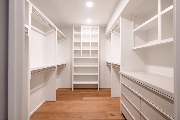 a view of walk in closet with empty racks