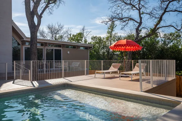 a view of a patio with a table and chairs