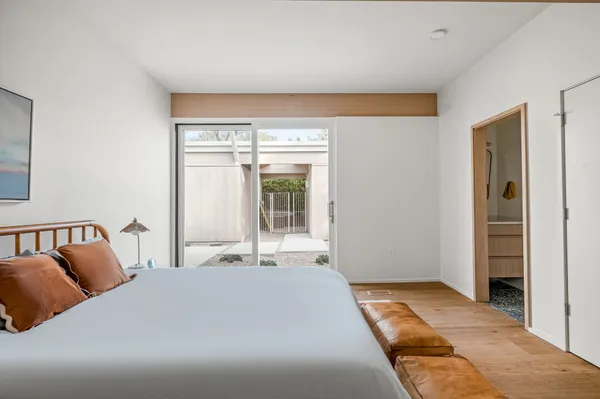 a bedroom with a large bed and a window