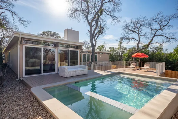 a view of a house with backyard porch and sitting area