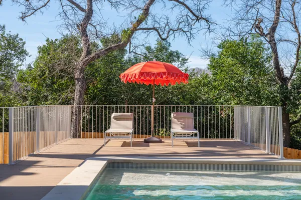 a view of balcony with wooden floor and seating space