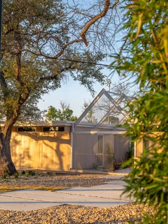 a bedroom with a bed and a potted plant
