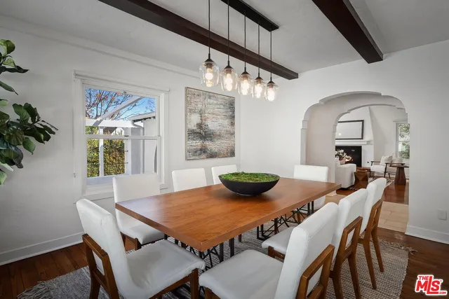 a kitchen with granite countertop white cabinets white appliances a sink and dishwasher