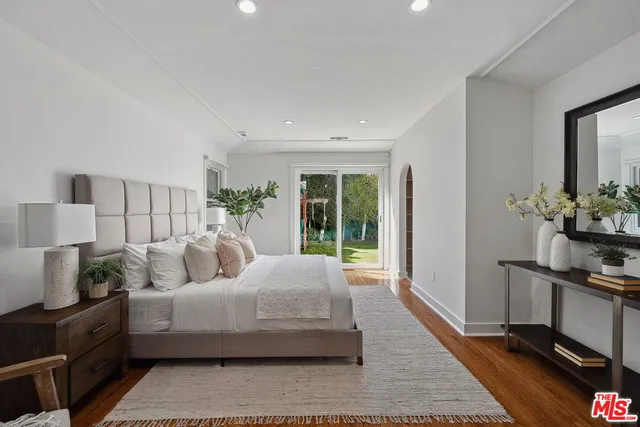 a bedroom with bed and a potted plant