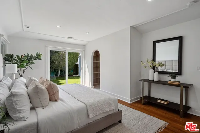 a view of bedroom with a bed and glass door