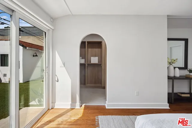 a view of walk in closet with empty racks