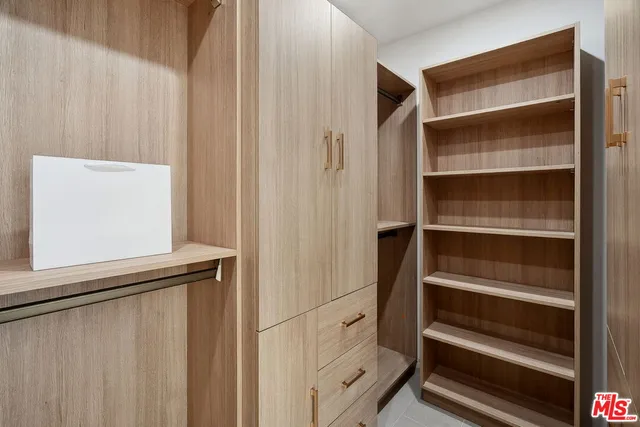 a spacious bathroom with a double vanity sink large mirror and bathtub