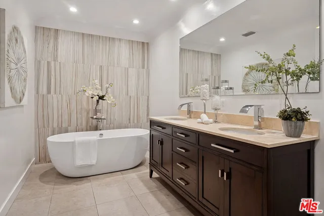 a bathroom with a sink double vanity and a shower