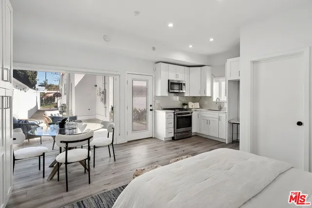 a view of a room with furniture and wooden floor