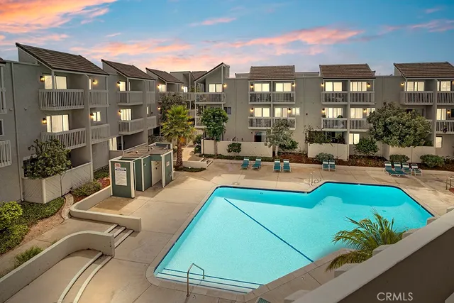 a kitchen with stainless steel appliances granite countertop a stove a microwave a sink a refrigerator dining table and chairs