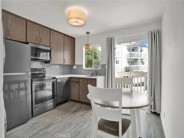 a kitchen with a stove and a refrigerator
