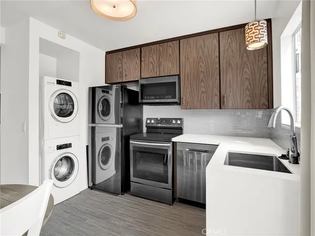 a view of a kitchen with wooden floor and cabinets
