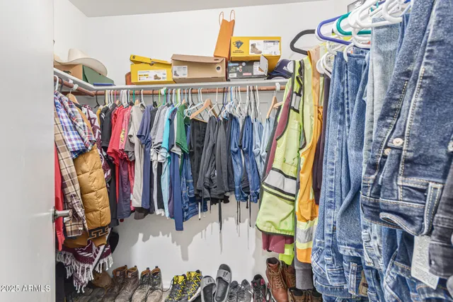 a view of walk in closet with clothes