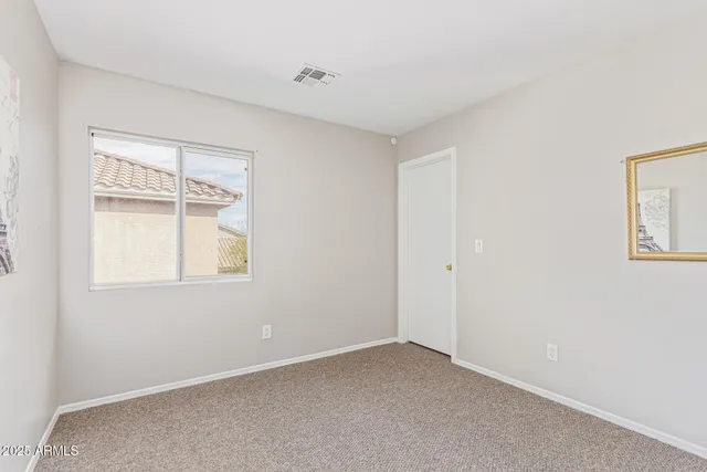 an empty room with windows and closet