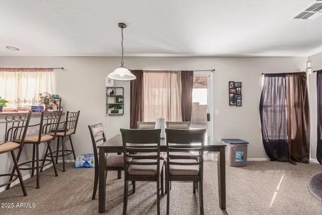 a dining room with furniture and window