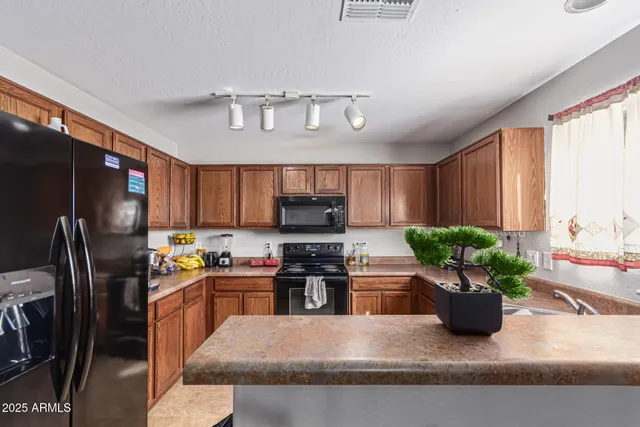 a kitchen with a refrigerator and a sink