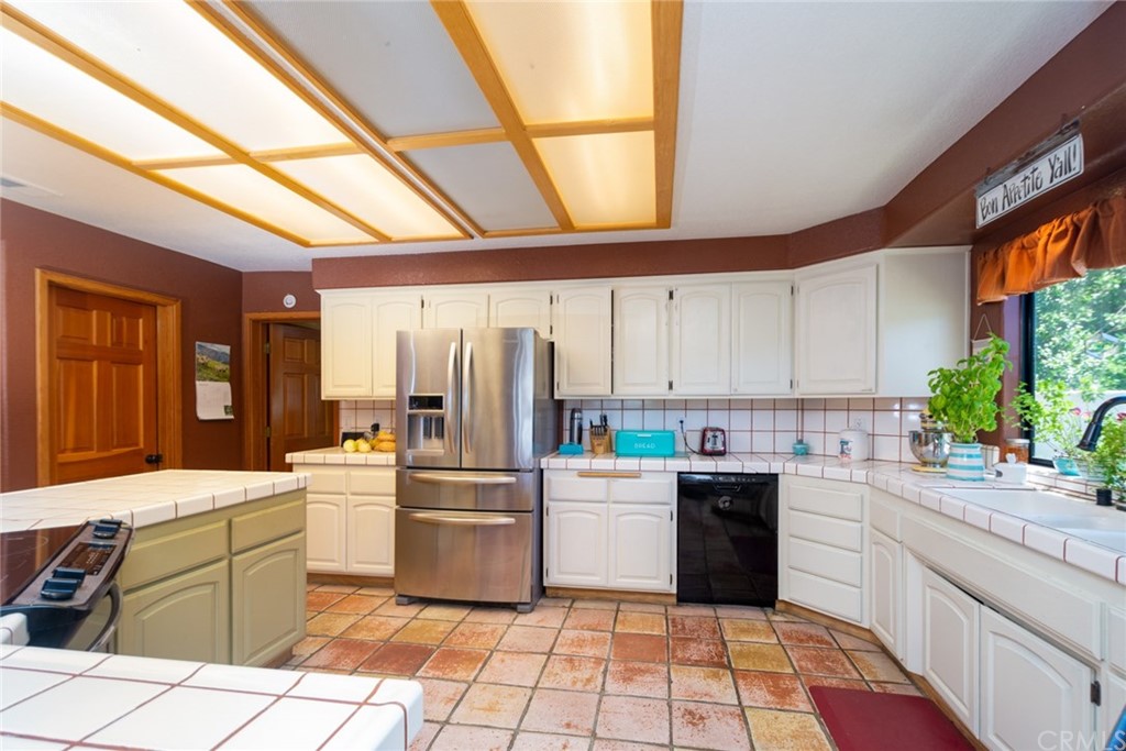 47810 Bee Canyon Truck Trail Hemet, CA 92544 - Photo 17 of 43 a kitchen with a sink window and cabinets