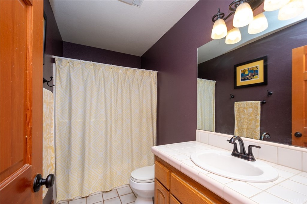 47810 Bee Canyon Truck Trail Hemet, CA 92544 - Photo 26 of 43 a bathroom with a sink and a mirror