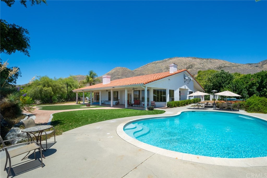 47810 Bee Canyon Truck Trail Hemet, CA 92544 - Photo 30 of 43 a view of a house with swimming pool and a yard
