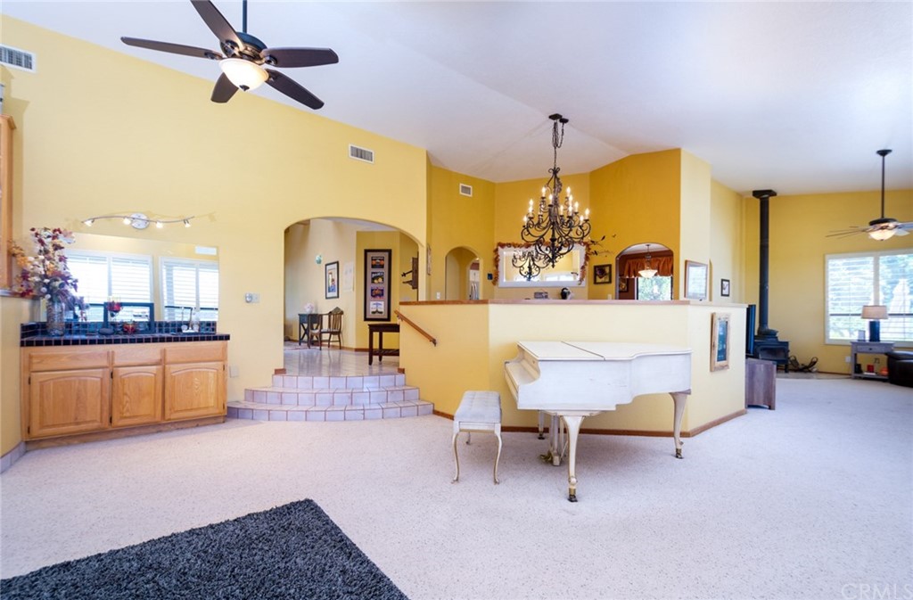 47810 Bee Canyon Truck Trail Hemet, CA 92544 - Photo 9 of 43 a living room with furniture a dining table and a fireplace