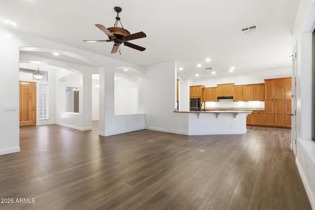 a view of a kitchen with refrigerator microwave and wooden floor