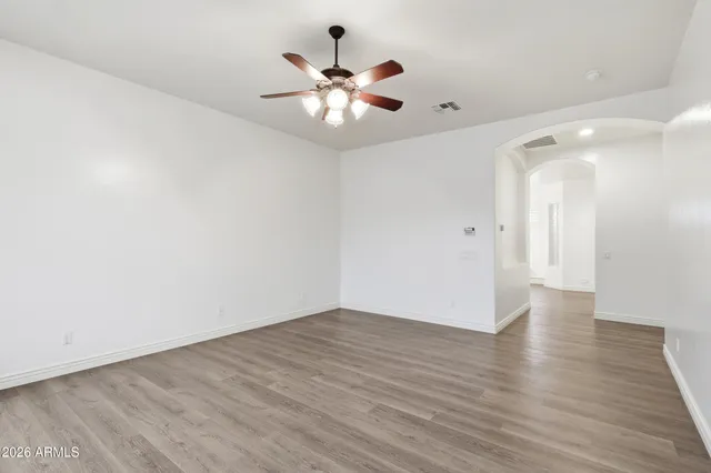 a large spacious bathroom with a granite countertop double vanity sink a mirror and a bathtub