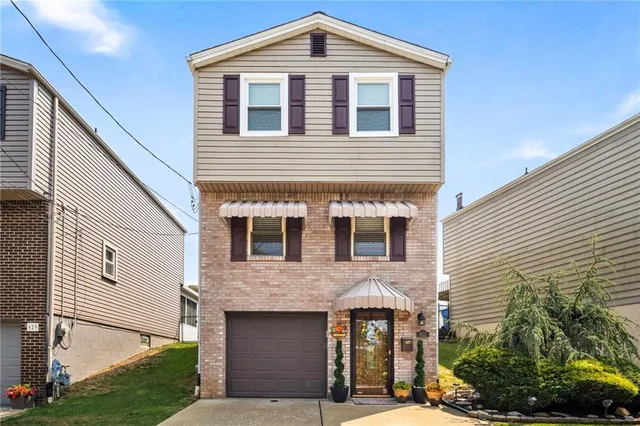 a front view of a house with a yard