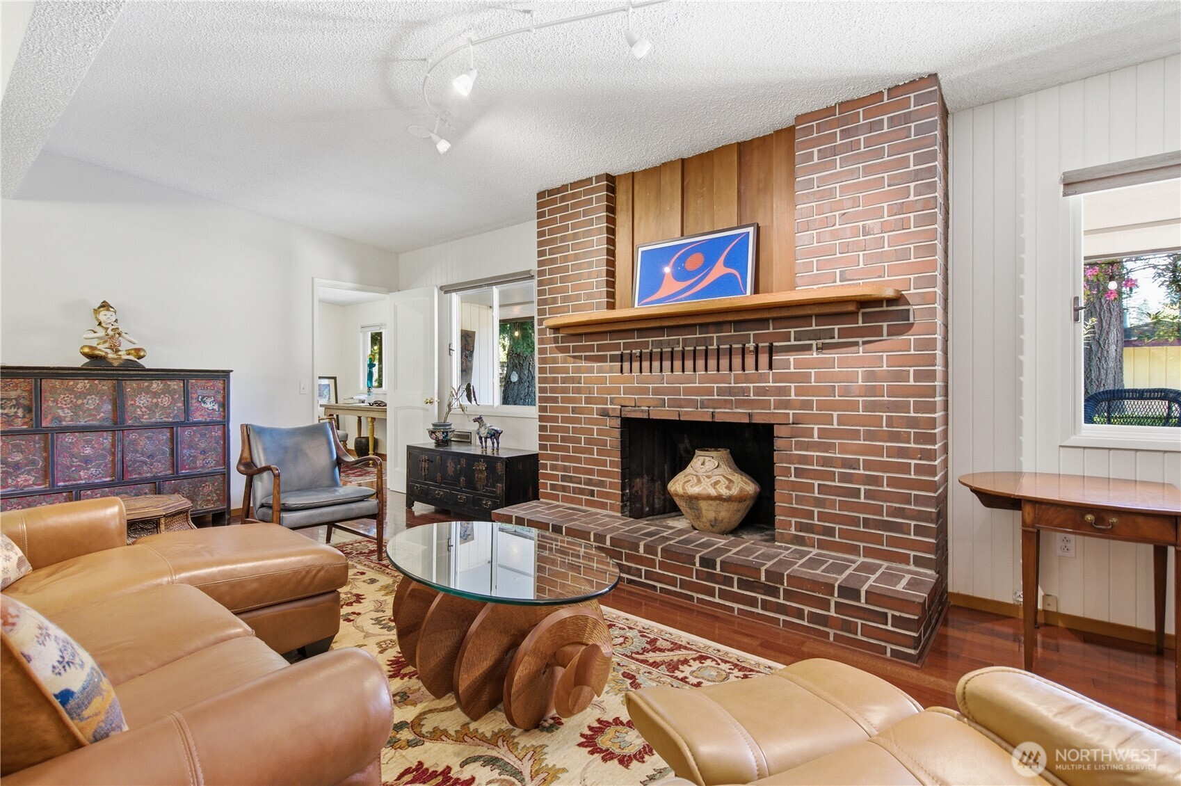 3050 Southeast Mullenix Road Port Orchard, WA 98367 - Photo 21 of 40 a living room with furniture a rug and a fireplace