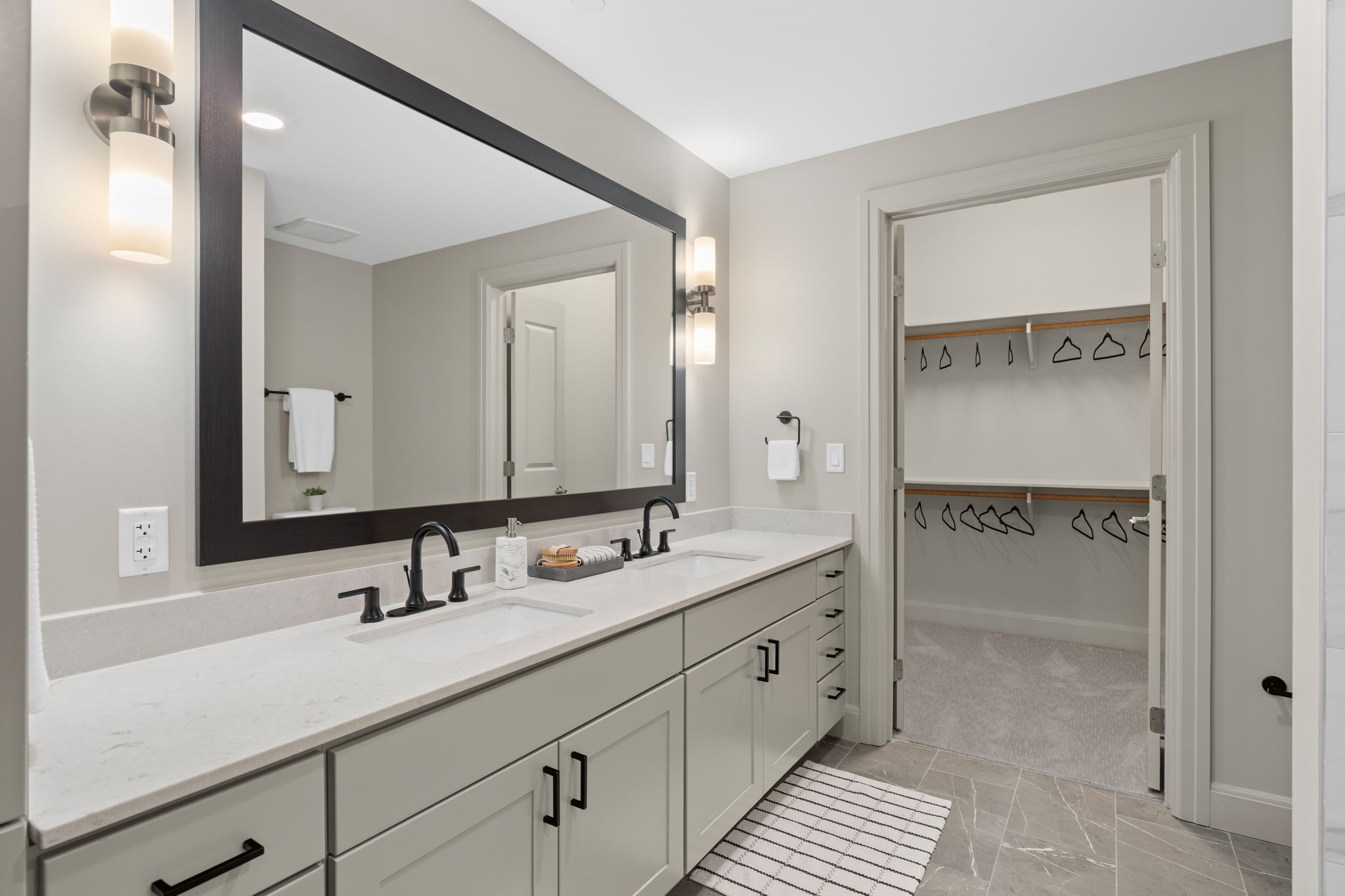 2511 Willowick Road, Unit 317 Houston, TX 77027 - Photo 16 of 44 a bathroom with a double vanity sink and mirror