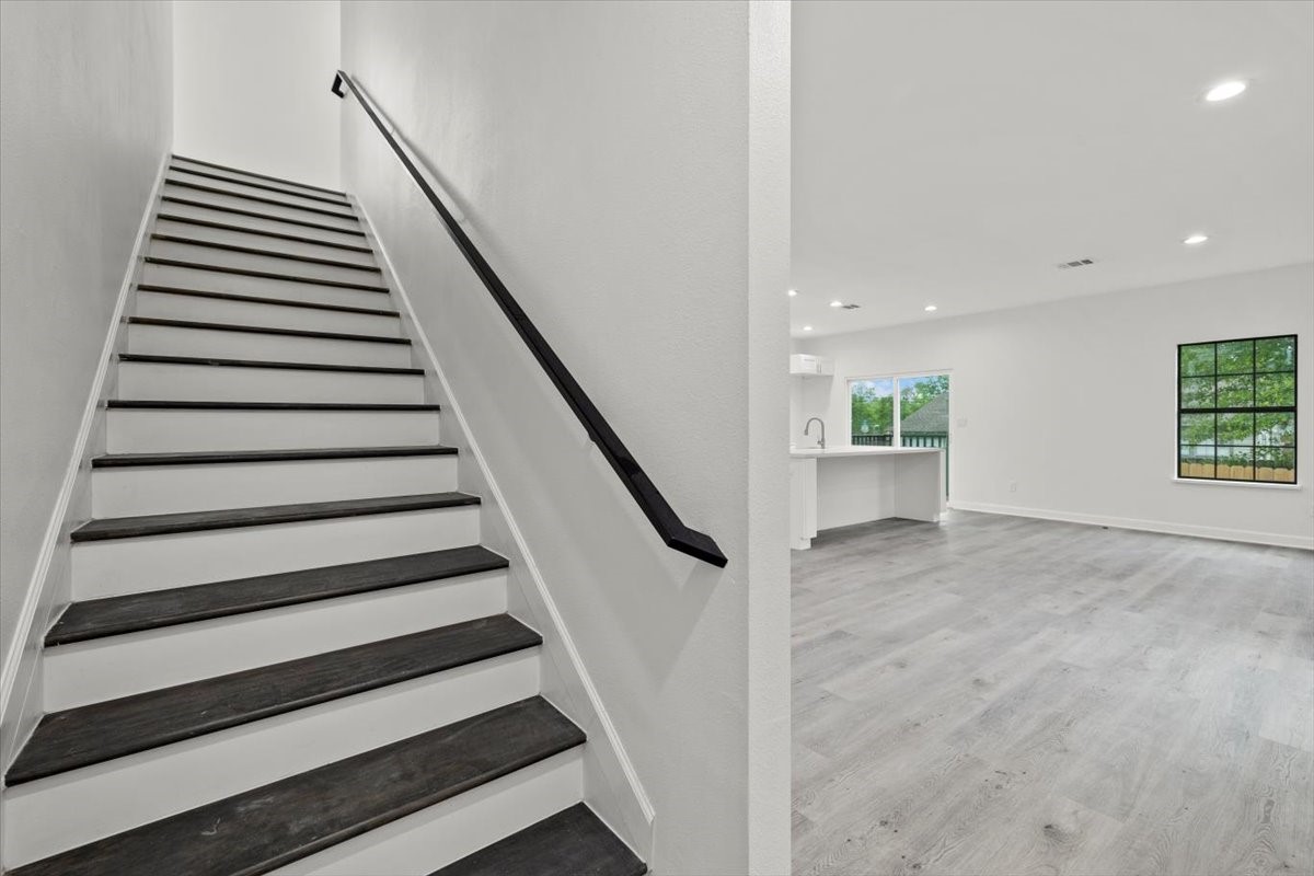 727 East 40th Street Houston, TX 77022 - Photo 11 of 22 a view of entryway with wooden floor and stairs